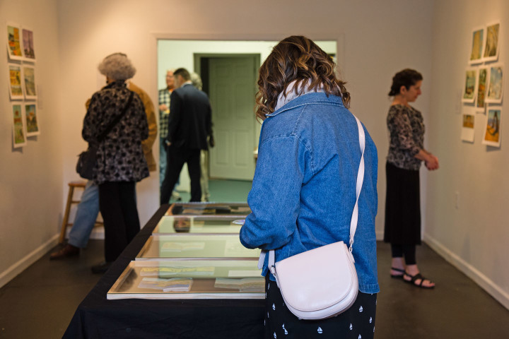 "Jaunt + Jot" exhibition featuring sketchbook drawings by Chandler O'Leary. Photo by Shawn H. Nichols, taken at the Artist Trust on Tour: Tacoma event.